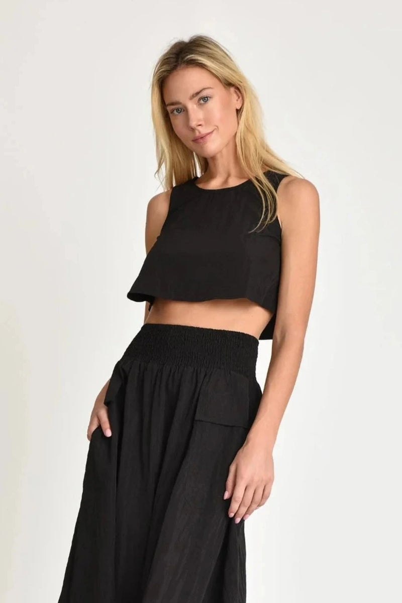 Woman wearing a black Nini top and maxi skirt from muche et muchette