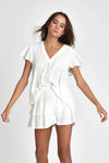 Woman wearing white Hailey top with a plain background